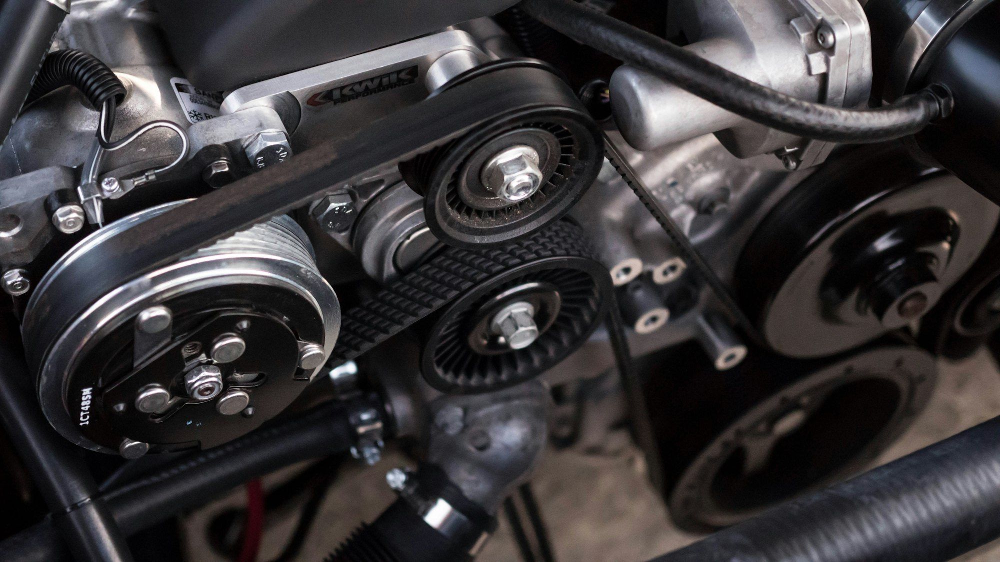 Belts and pulleys of a car engine, including the airco compressor drive