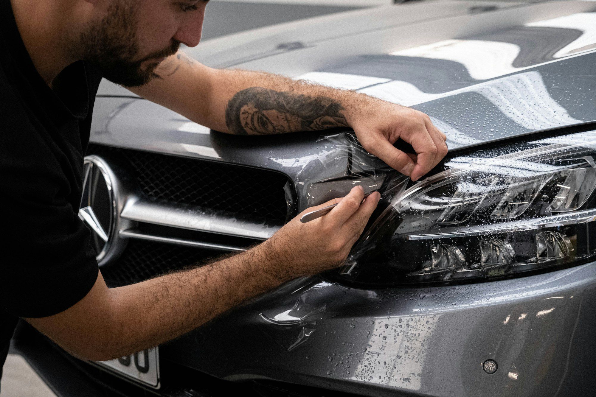 A headlight being polished by hand