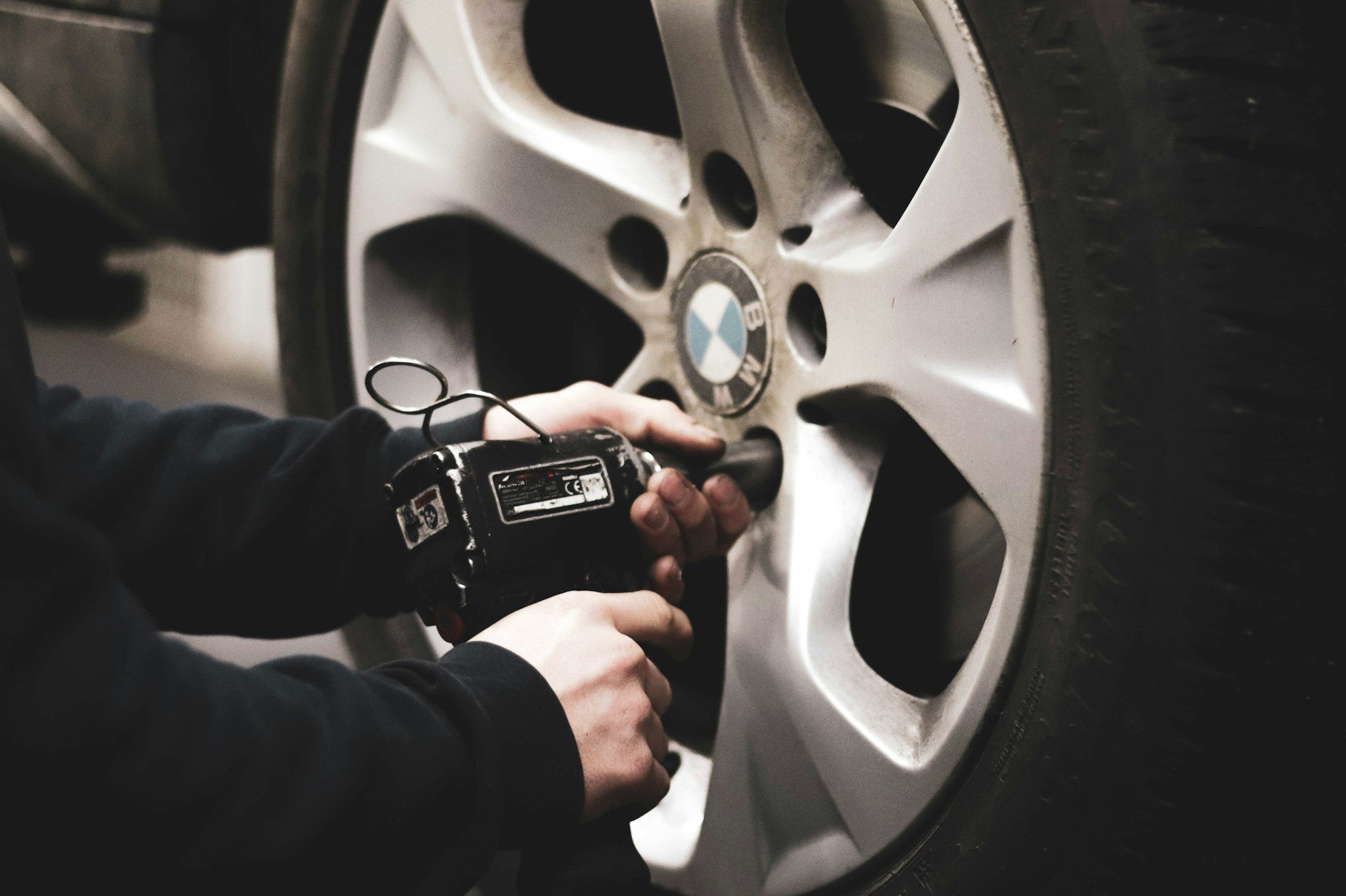 Wheel nuts being removed with an impact wrench